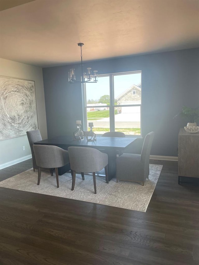 3390 Evening Star Dr, Green Bay, WI 54311 - dining space featuring a chandelier, baseboards, and wood finished floors