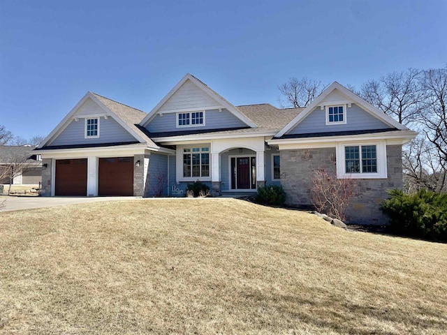 E12275 Timber Ridge Trl, Prairie Du Sac, WI 53578 - craftsman inspired home featuring roof with shingles, stone siding, concrete driveway, a garage, and a front lawn