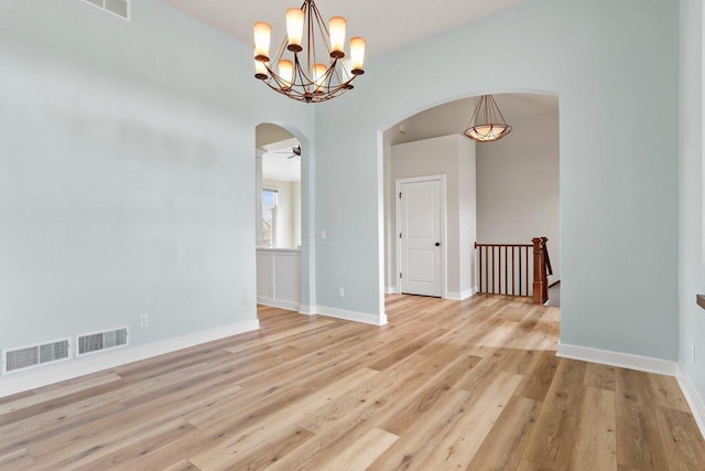 E12275 Timber Ridge Trl, Prairie Du Sac, WI 53578 - unfurnished dining area with light wood finished floors, arched walkways, and visible vents
