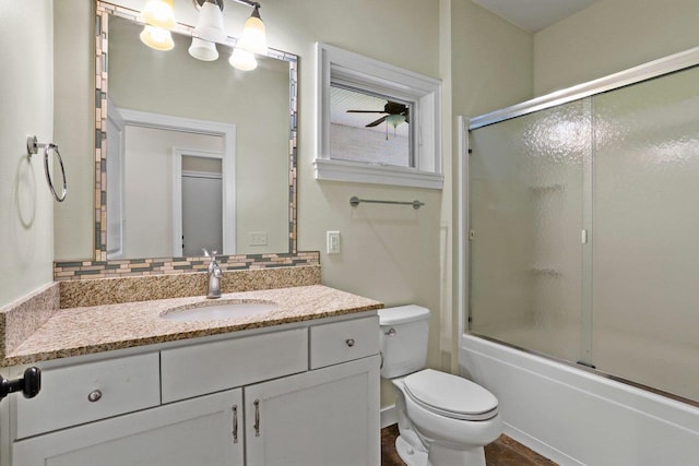 E12275 Timber Ridge Trl, Prairie Du Sac, WI 53578 - bathroom featuring toilet, tasteful backsplash, vanity, bath / shower combo with glass door, and a ceiling fan