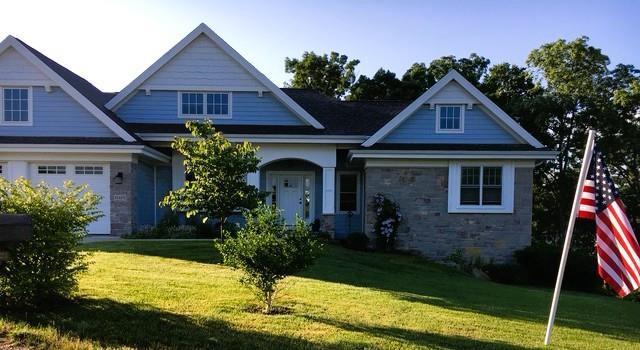E12275 Timber Ridge Trl, Prairie Du Sac, WI 53578 - craftsman-style home featuring stone siding and a front lawn