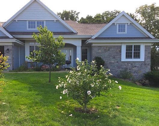 E12275 Timber Ridge Trl, Prairie Du Sac, WI 53578 - craftsman house featuring a front lawn and stone siding