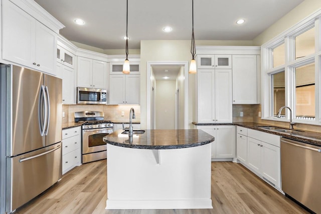 E12275 Timber Ridge Trl, Prairie Du Sac, WI 53578 - kitchen with a sink, backsplash, light wood-style floors, and appliances with stainless steel finishes