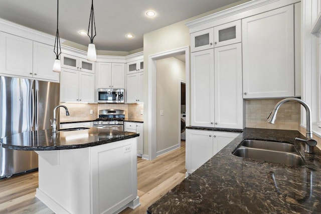 E12275 Timber Ridge Trl, Prairie Du Sac, WI 53578 - kitchen featuring decorative backsplash, light wood-style flooring, appliances with stainless steel finishes, and a sink