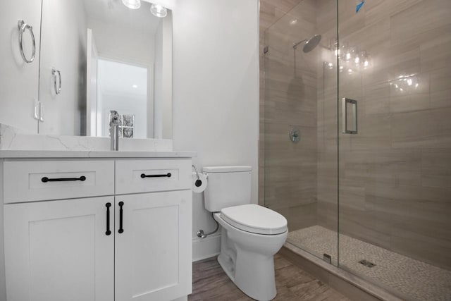 N2692 Forest Dr, Lake Geneva, WI 53147 - full bath with toilet, a stall shower, vanity, and wood finished floors