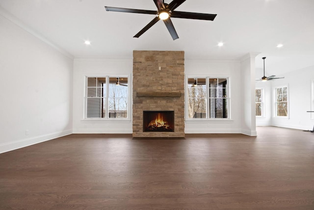 N2692 Forest Dr, Lake Geneva, WI 53147 - unfurnished living room with ceiling fan, dark wood-style flooring, a fireplace, ornamental molding, and baseboards