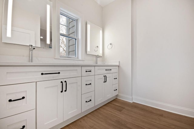 N2692 Forest Dr, Lake Geneva, WI 53147 - full bath with double vanity, wood finished floors, and baseboards