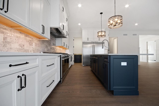 N2692 Forest Dr, Lake Geneva, WI 53147 - kitchen with stainless steel appliances, ornamental molding, ventilation hood, tasteful backsplash, and a kitchen island with sink