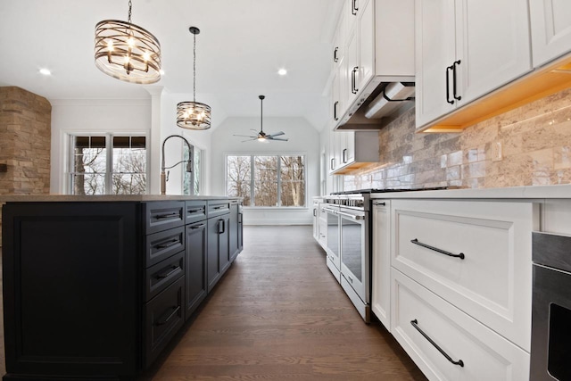 N2692 Forest Dr, Lake Geneva, WI 53147 - kitchen with high end stainless steel range oven, custom exhaust hood, dark wood-type flooring, a ceiling fan, and white cabinetry