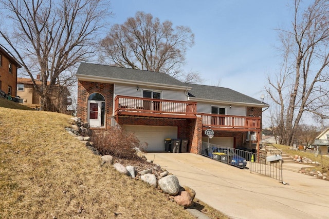 view of front of house featuring driveway, stairway, a deck, an attached garage, and brick siding