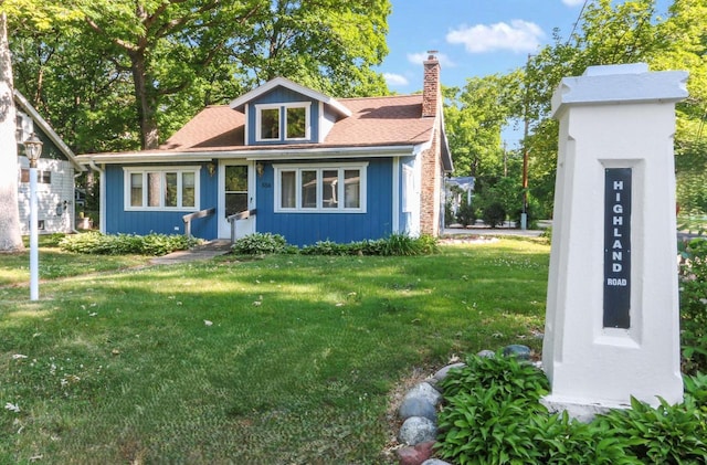 556 Highland Rd, Williams Bay, WI 53191 - bungalow with a front yard and a chimney