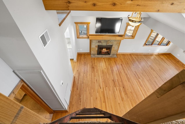 556 Highland Rd, Williams Bay, WI 53191 - unfurnished living room featuring wood finished floors, baseboards, a fireplace, and stairs