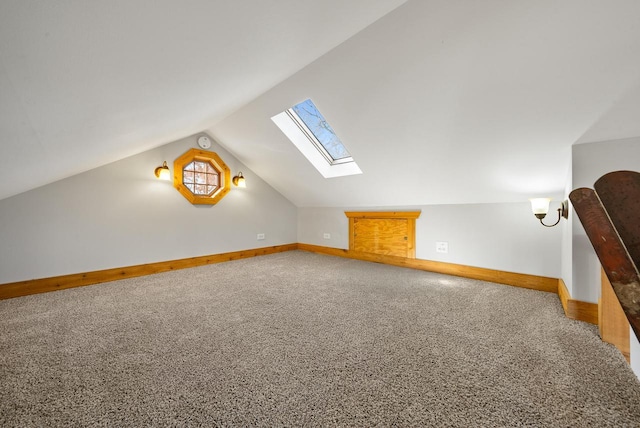 556 Highland Rd, Williams Bay, WI 53191 - additional living space with a skylight, baseboards, lofted ceiling, and carpet flooring