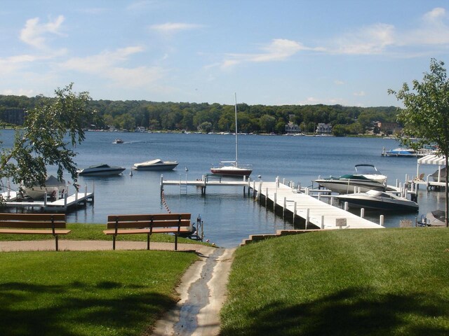 556 Highland Rd, Williams Bay, WI 53191 - dock area featuring a water view and a yard