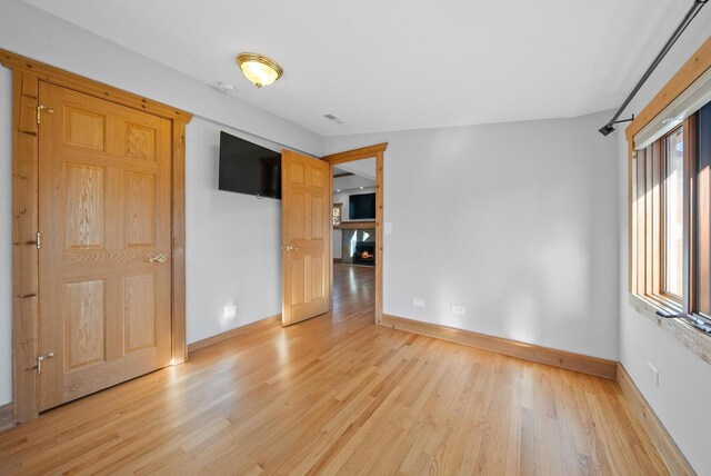 556 Highland Rd, Williams Bay, WI 53191 - unfurnished bedroom with light wood-style floors and baseboards