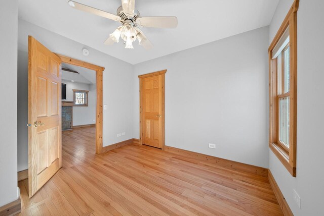 556 Highland Rd, Williams Bay, WI 53191 - unfurnished room with light wood-style flooring, baseboards, and a ceiling fan