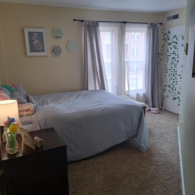 bedroom with visible vents and carpet