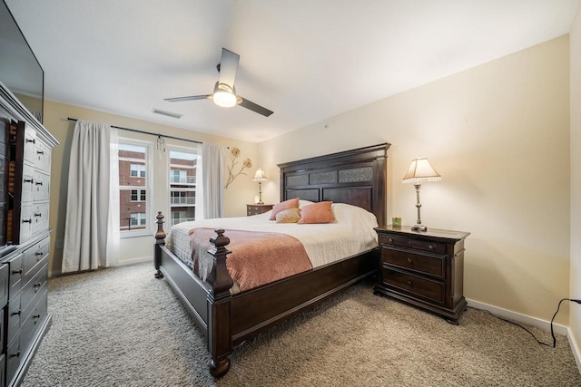 bedroom with baseboards, visible vents, a ceiling fan, and light carpet
