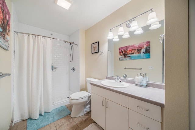 bathroom with toilet, vanity, a stall shower, and tile patterned flooring
