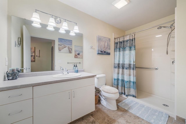 full bathroom with vanity, toilet, and a shower stall