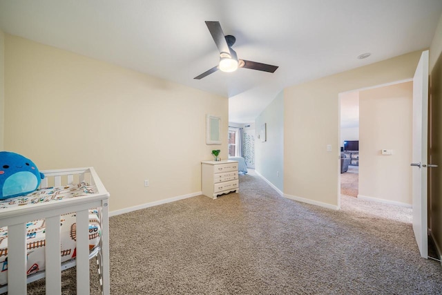 unfurnished bedroom featuring baseboards, ceiling fan, and carpet