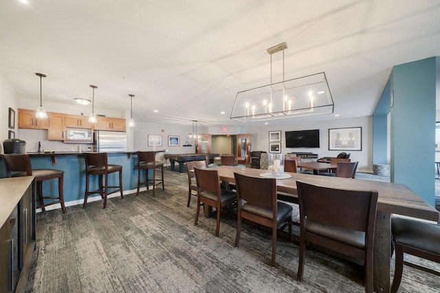 dining space with baseboards, recessed lighting, and dark colored carpet
