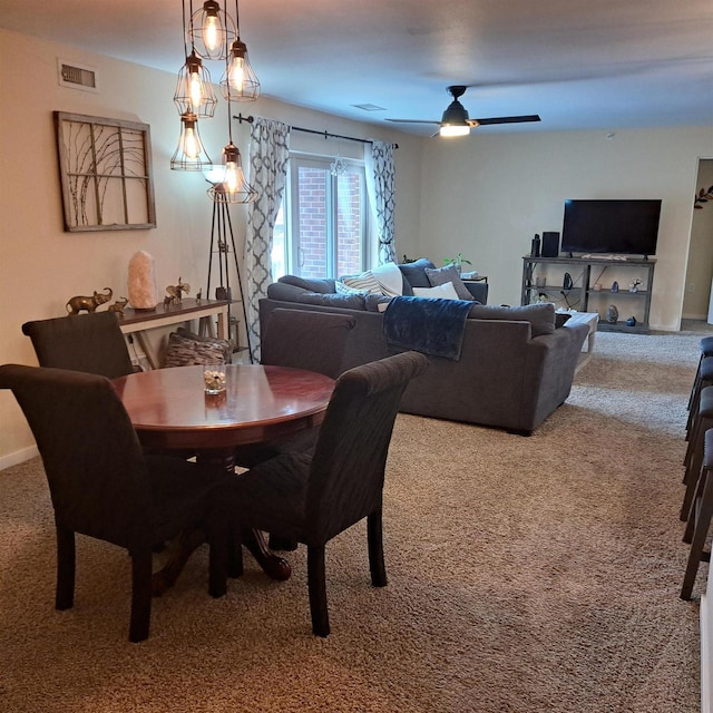 dining room featuring ceiling fan, visible vents, and carpet