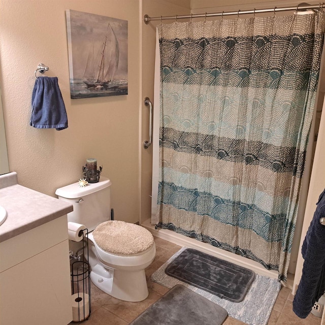bathroom with a shower with curtain, tile patterned flooring, vanity, and toilet