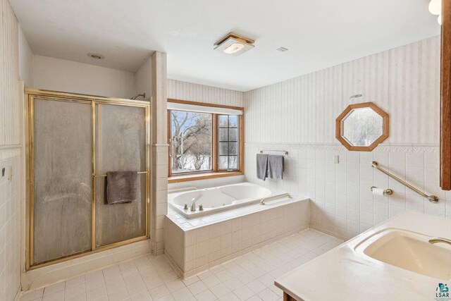 2507 Junction Rd, Ashland, WI 54806 - full bathroom featuring a stall shower, tile patterned floors, a bath, and tile walls