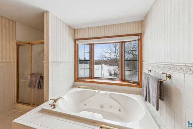 2507 Junction Rd, Ashland, WI 54806 - full bathroom with tile walls, wallpapered walls, a stall shower, a jetted tub, and wainscoting