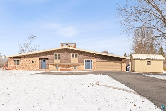 2507 Junction Rd, Ashland, WI 54806 - view of front of home with an outdoor structure, driveway, a garage, and a storage shed