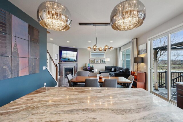 328 Venus Way, Madison, WI 53718 - dining room featuring stairs, a fireplace, recessed lighting, and a notable chandelier