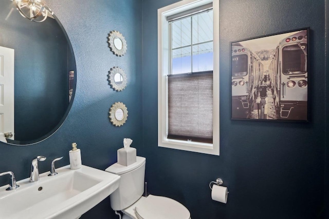328 Venus Way, Madison, WI 53718 - half bath featuring a textured wall, toilet, and a sink