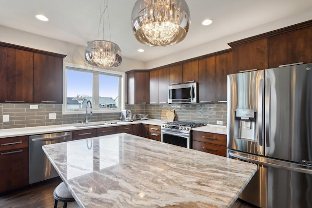 328 Venus Way, Madison, WI 53718 - kitchen featuring decorative backsplash, a sink, a notable chandelier, and appliances with stainless steel finishes
