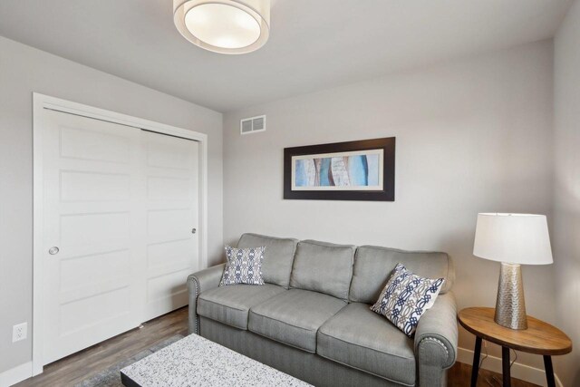 328 Venus Way, Madison, WI 53718 - living area featuring dark wood-style floors, visible vents, and baseboards