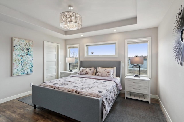 328 Venus Way, Madison, WI 53718 - bedroom with an inviting chandelier, a raised ceiling, dark wood-type flooring, and baseboards