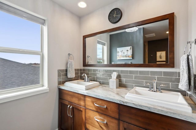 328 Venus Way, Madison, WI 53718 - bathroom with double vanity, decorative backsplash, and a sink