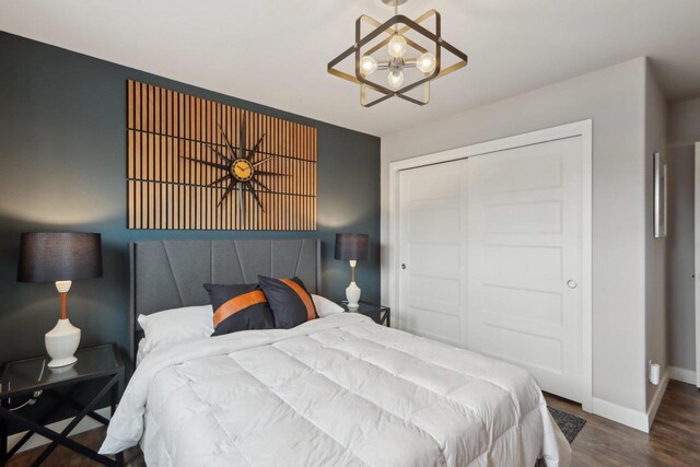 328 Venus Way, Madison, WI 53718 - bedroom with baseboards, a closet, wood finished floors, and a chandelier