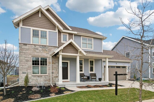 328 Venus Way, Madison, WI 53718 - craftsman-style home with driveway, covered porch, stone siding, and a garage