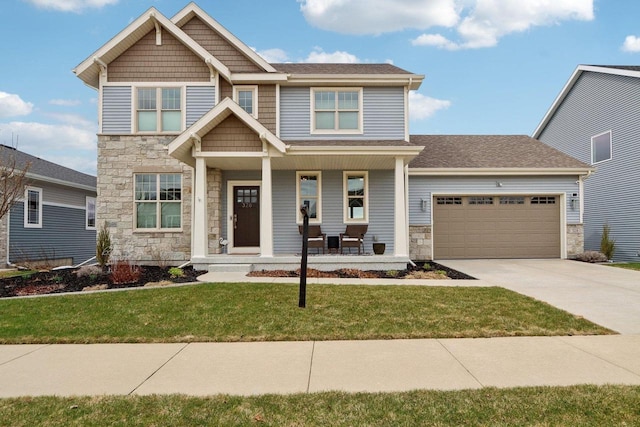 328 Venus Way, Madison, WI 53718 - craftsman-style home with concrete driveway, stone siding, a front yard, a porch, and a garage