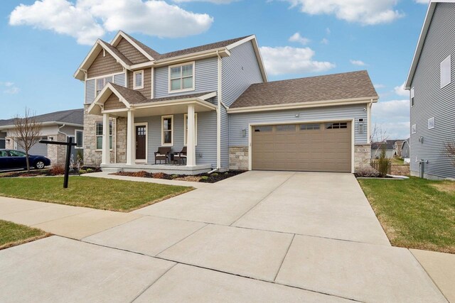 328 Venus Way, Madison, WI 53718 - craftsman house featuring stone siding, driveway, and a porch