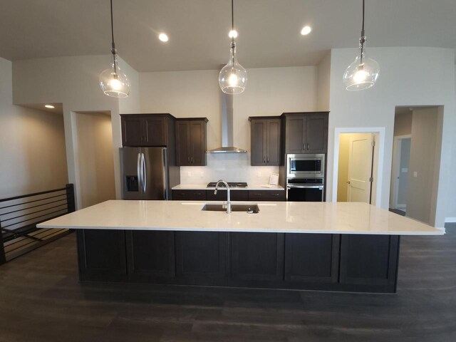 5684 N Kestrel Cir, Appleton, WI 54913 - kitchen featuring a large island with sink, light countertops, a sink, wall chimney exhaust hood, and appliances with stainless steel finishes