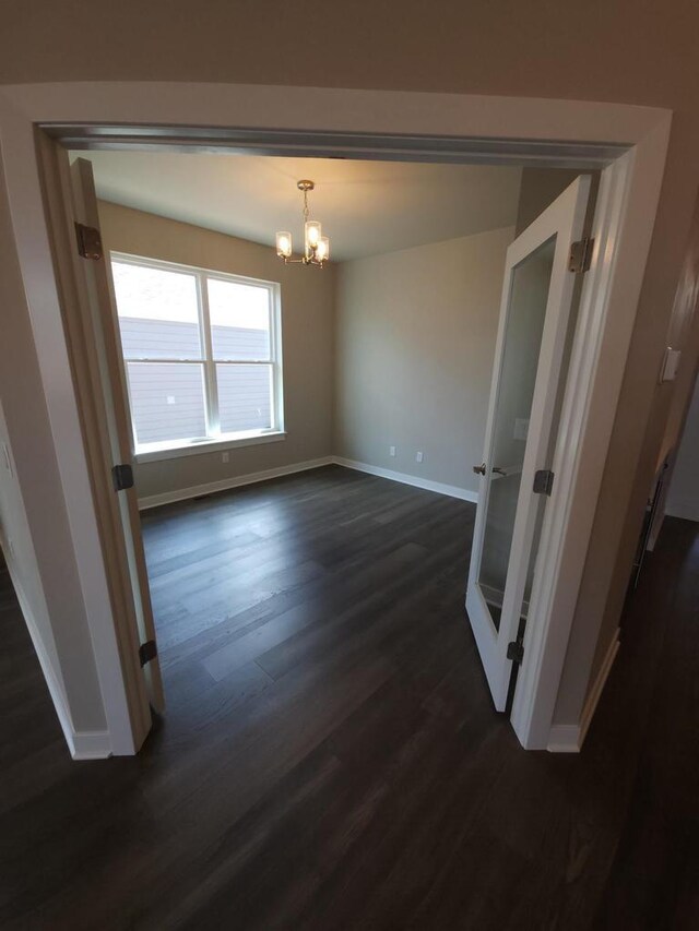 5684 N Kestrel Cir, Appleton, WI 54913 - unfurnished dining area featuring baseboards, a notable chandelier, and dark wood-style flooring