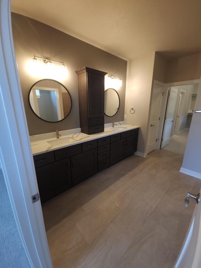 5684 N Kestrel Cir, Appleton, WI 54913 - bathroom featuring double vanity, a sink, and baseboards