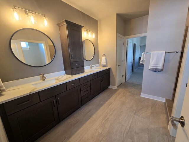 5684 N Kestrel Cir, Appleton, WI 54913 - bathroom with baseboards, double vanity, and a sink