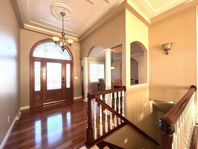 25621 Honeycut Ave, Tomah, WI 54660 - entrance foyer with a chandelier, crown molding, baseboards, wood finished floors, and arched walkways