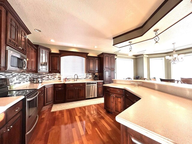 25621 Honeycut Ave, Tomah, WI 54660 - kitchen with light countertops, appliances with stainless steel finishes, and a chandelier