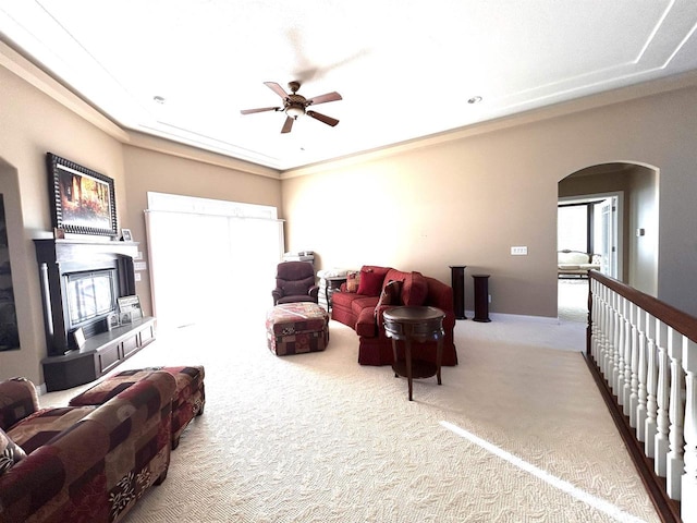 25621 Honeycut Ave, Tomah, WI 54660 - living area with arched walkways, ceiling fan, a glass covered fireplace, and carpet