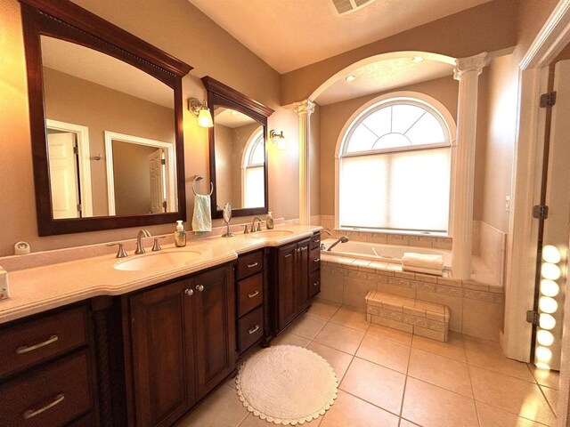 25621 Honeycut Ave, Tomah, WI 54660 - full bath featuring a bath, a sink, tile patterned floors, and decorative columns