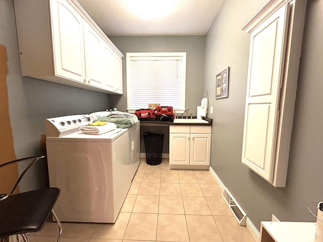25621 Honeycut Ave, Tomah, WI 54660 - laundry room with light tile patterned flooring, visible vents, cabinet space, a sink, and washing machine and dryer